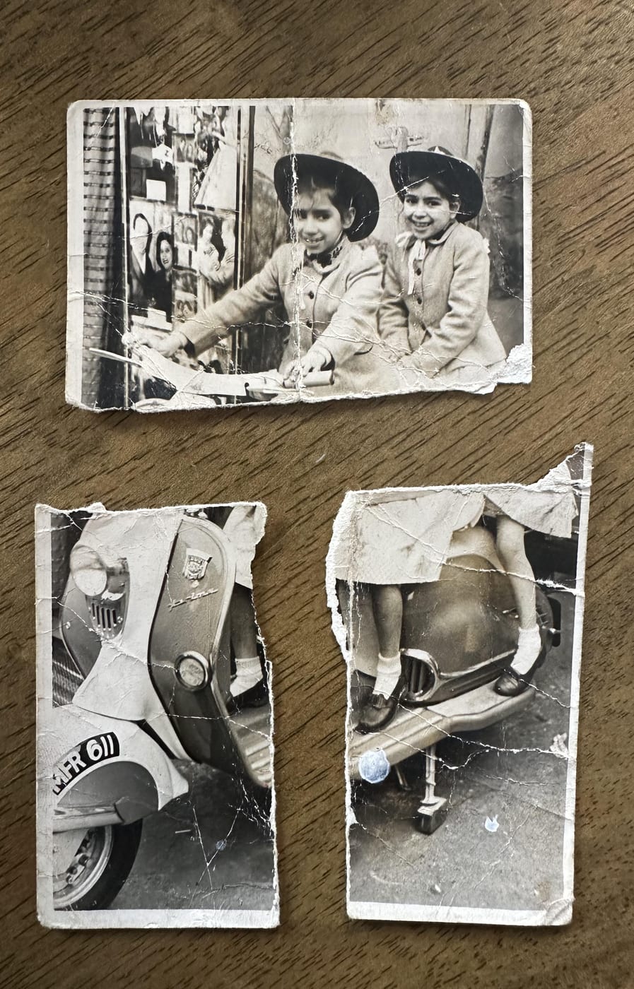Restored photograph of two sisters in wide-brimmed hats sitting on a 1950s motor scooter
